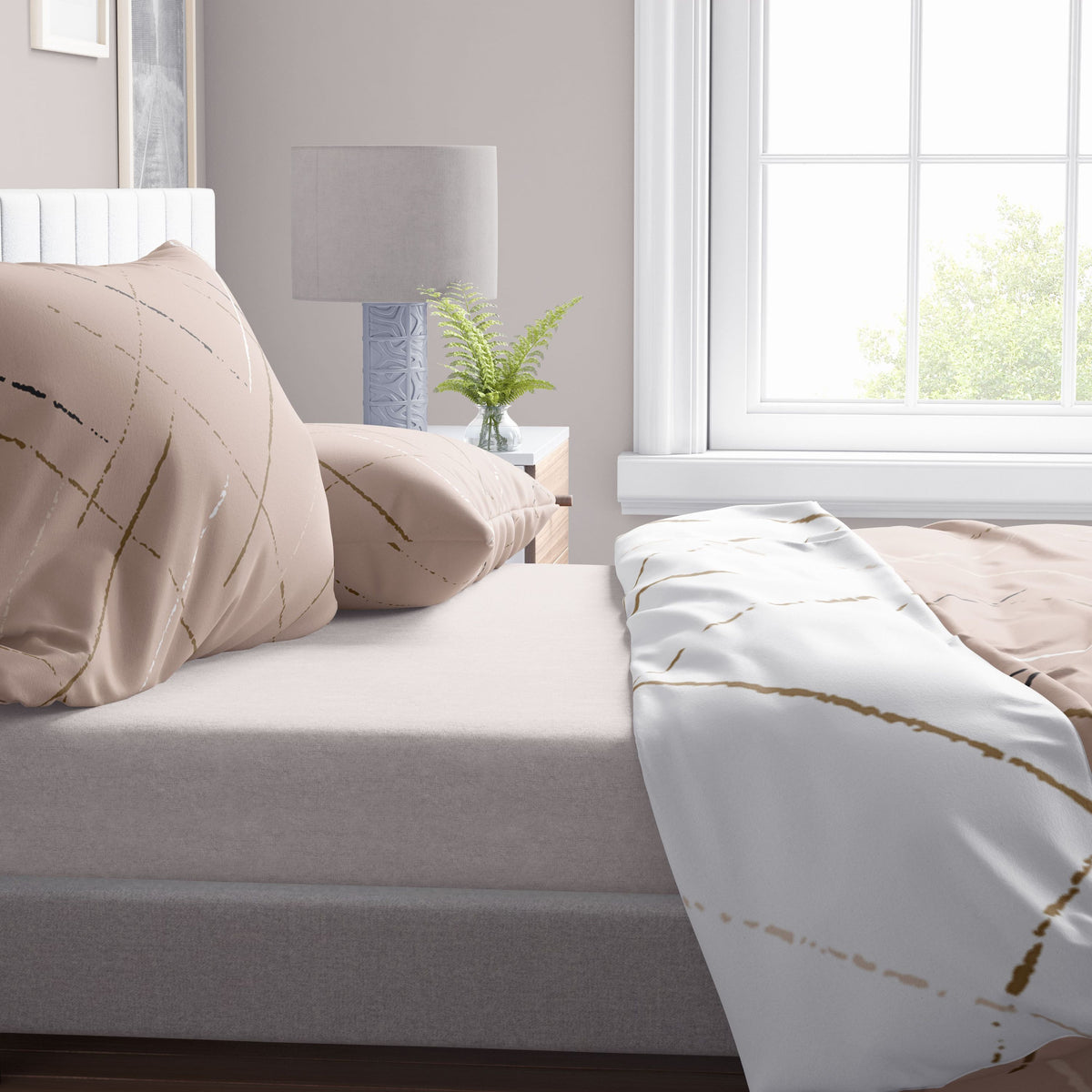 Beige-weiße Wendebettwäsche mit modernem Linienmuster in Nahaufnahme – weiche Kissen und aufgeschlagene Decke auf einem hellen Boxspringbett, Tageslicht durch Fenster.